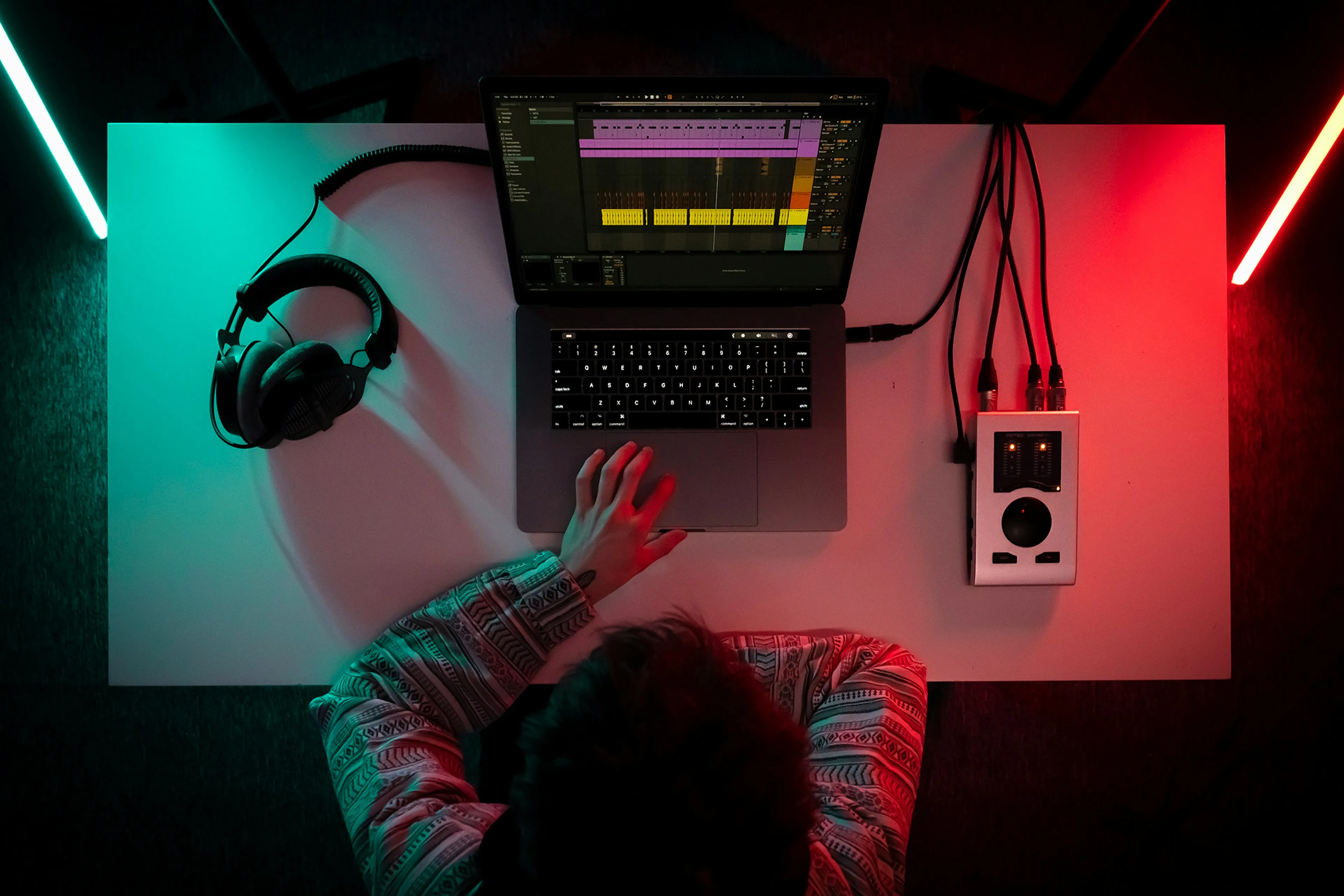 Overhead shot of a producer at a laptop running a DAW