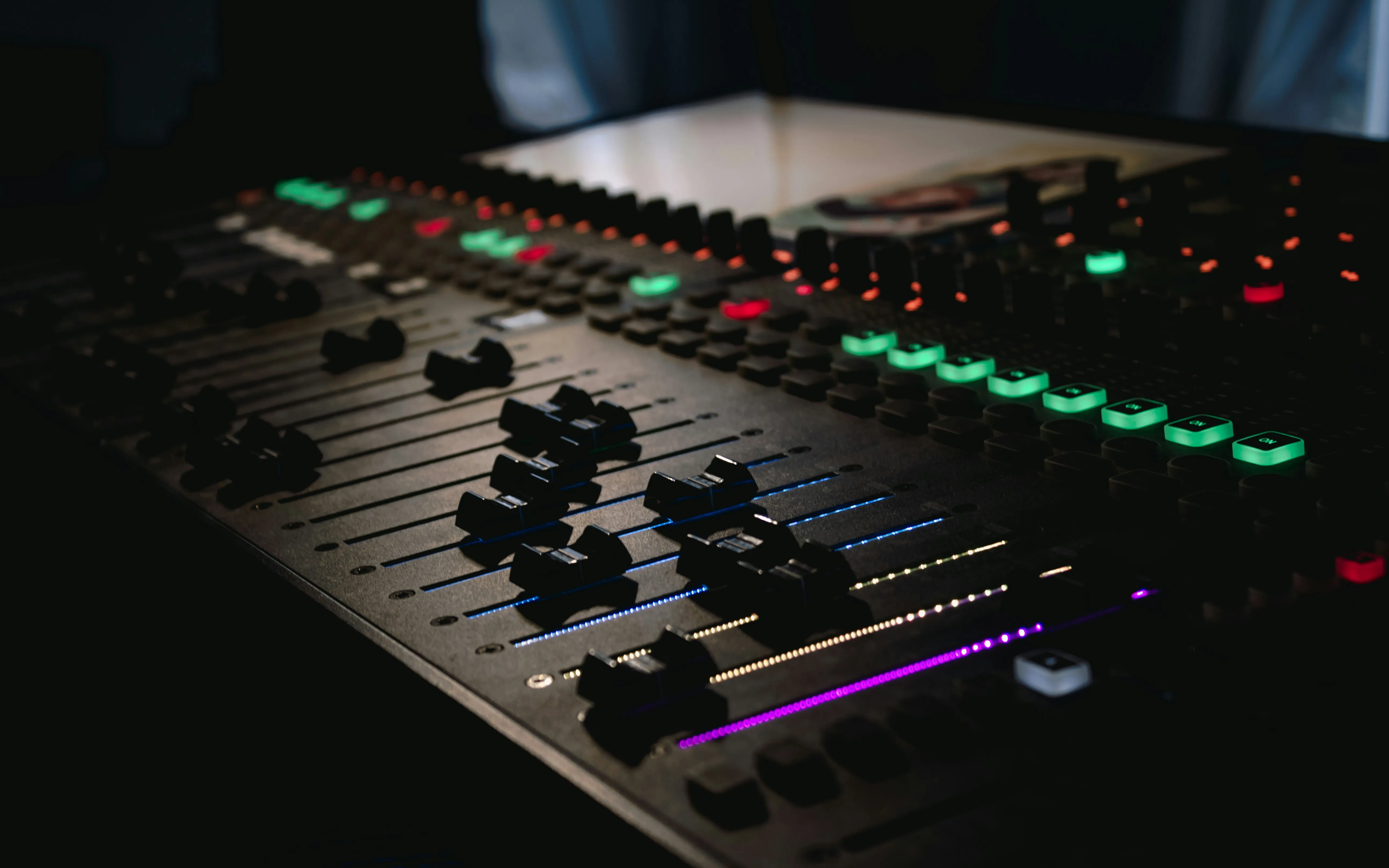 Close-up of a lit professional mixing desk